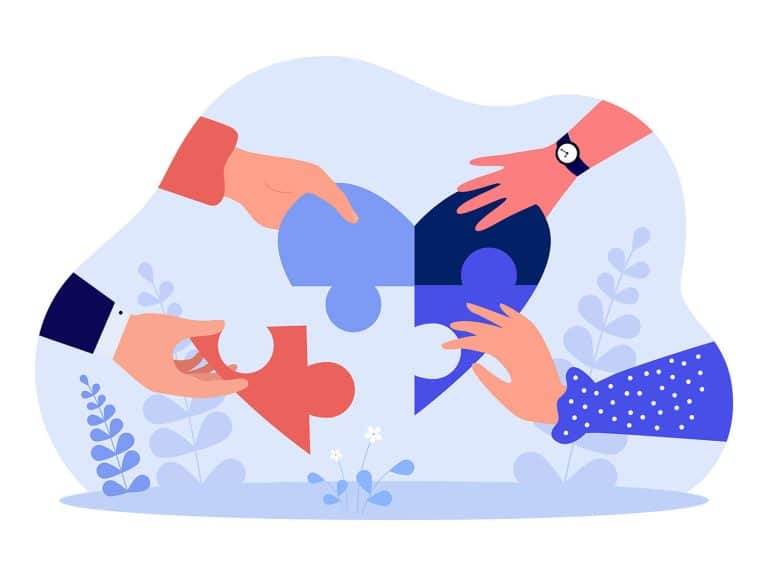 Hands of people forming heart from puzzle pieces